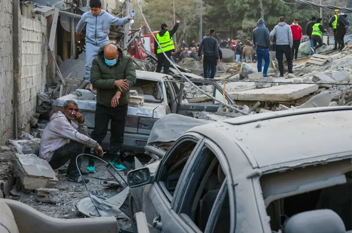  People tend to the injured as rescue workers search the rubble of residential buildings in Beirut&rsquo;s Bashoura neighbourhood, after Israel struck the area without warning.&mdash;AFP 