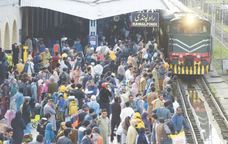  Crowds gather at Rawalpindi Railway Station and the Faizabad bus terminal on Thursday as they travel to their hometowns to celebrate Eid with their loved ones. &mdash; Photos by Mohammad Asim 