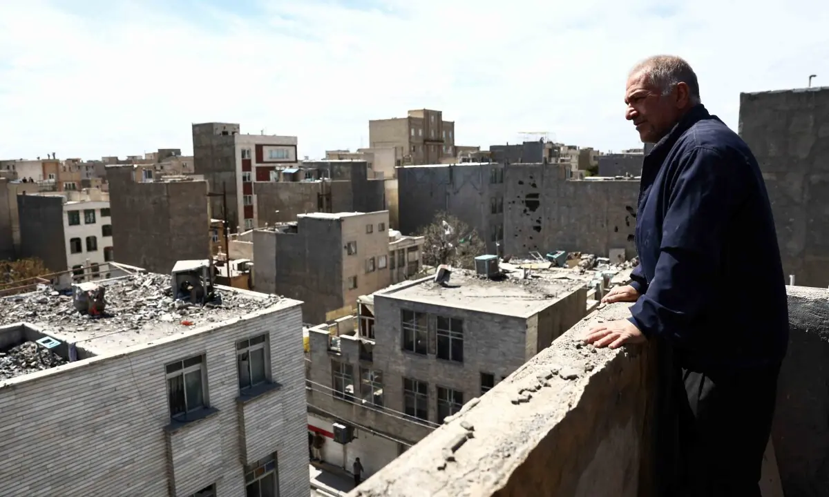A man looks at a residential building damaged by a strike, amid the US-Israeli war on Iran, in Tehran, Iran, March 27, 2026. — AFP