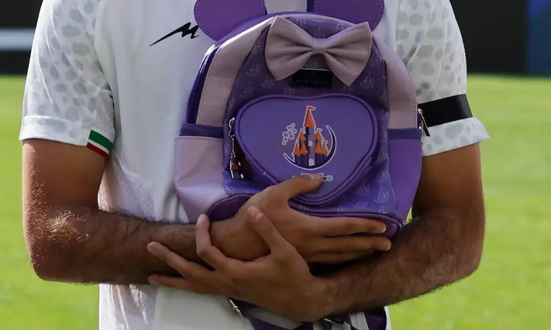 Iran players line up before the match as school bags are laid in memory of the victims of the girls school bombing in Minab, Iran, March 27, 2026. &mdash; Reuters