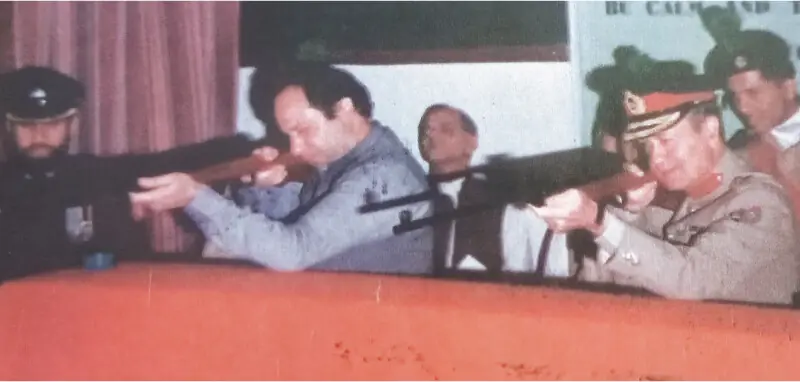 A photograph from the 1980s of Lt Gen Talat Masood taking aim with the then Chief Minister of Punjab Nawaz Sharif at the Pakistan Ordinance Factories | Photo from the book