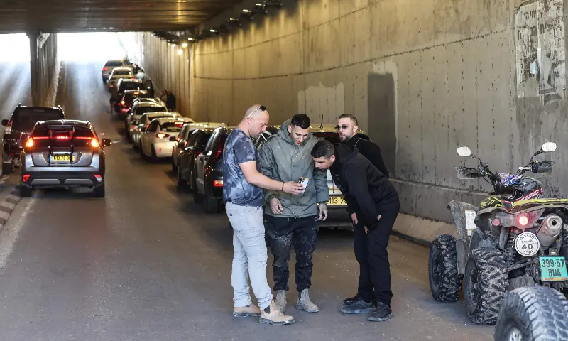 People take shelter inside a tunnel near Abu Ghosh as missile-warning sirens sound on March 28, 2026. &mdash; AFP