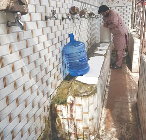 NAROWAL: Bricks have been placed on taps to stop water leak. — Dawn