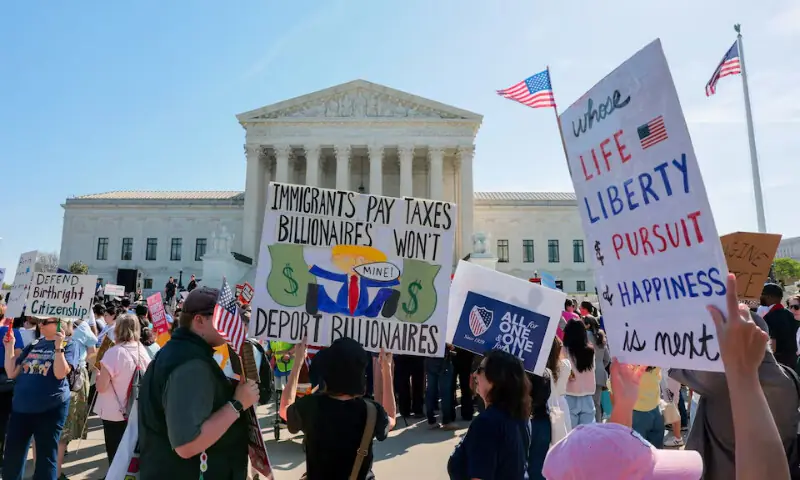 Demonstrators hold signs outside the US Supreme Court building on the day the court is expected to hear oral arguments on the legality of the Trump administration&rsquo;s effort to limit birthright citizenship for the children of immigrants, in Washington, D.C., US, April 1, 2026. &mdash; Reuters
