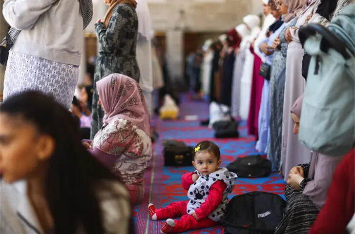  A May 2023 photo of a child looking on as women pray during Friday prayer in Istanbul&rsquo;s Blue Mosque: in Turkey, women&rsquo;s sections of the mosques are often full of children | Reuters 