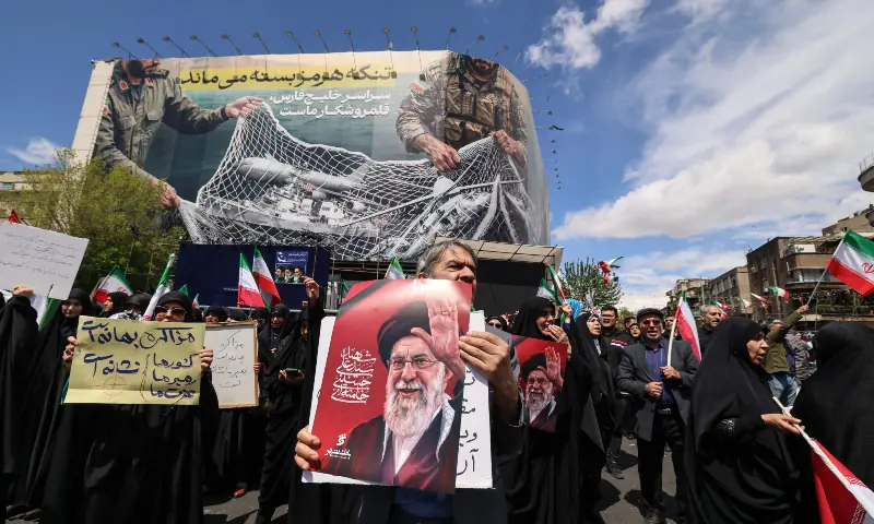 Iranians hold portraits of the country&rsquo;s slain supreme leader Ayatollah Ali Khamenei as they gather in Tehran&rsquo;s Revolution Square after the United States and Iran agreed to a two-week ceasefire, on April 8, 2026. &mdash; AFP