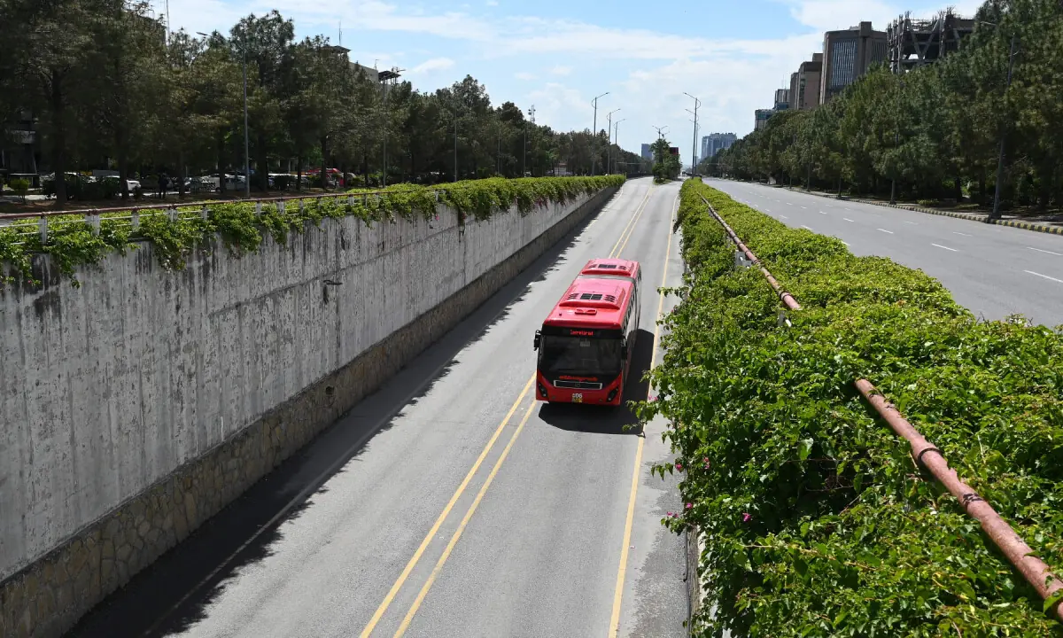 A bus is seen on a deserted street after authorities blocked roads in the Red Zone area in Islamabad on April 9, 2026. &mdash; AFP