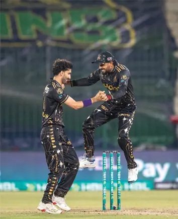 PESHAWAR ZALMI spinner Sufiyan Muqeem (L) celebrates with captain Babar Azam after taking a wicket during the Pakistan Super League match against Multan Sultans at the National Bank Stadium. —Courtesy Peshawar Zalmi