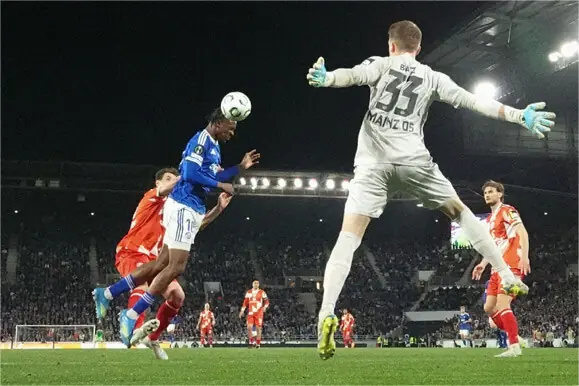 STRASBOURG: Emanuel Emegha (second L) of Strasbourg heads to score past Mainz goalkeeper Daniel Batz during their Conference League quarter-final second leg at Stade de La Meinau.—AFP