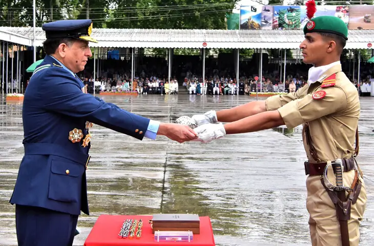   ABBOTTABAD: Air Chief Marshal Zaheer Ahmed Baber Sidhu awards Sword of Honour to Academy Senior Under Officer Bilal Nasim during the pas&shy;sing-out parade at Pakistan Military Academy, Kakul.&mdash;Online  