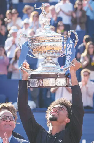 FRANCE’S Arthur Fils lifts the Barcelona Open trophy after winning the final against Andrey Rublev of Russia at Real Club de Tenis Barcelona on Sunday.—AFP