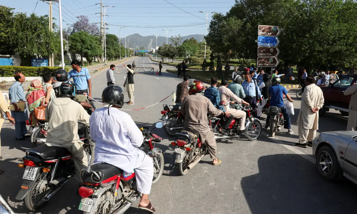 Police officers divert the traffic on a road leading to Serena hotel in Islamabad on April 20, 2026. &mdash; Reuters
