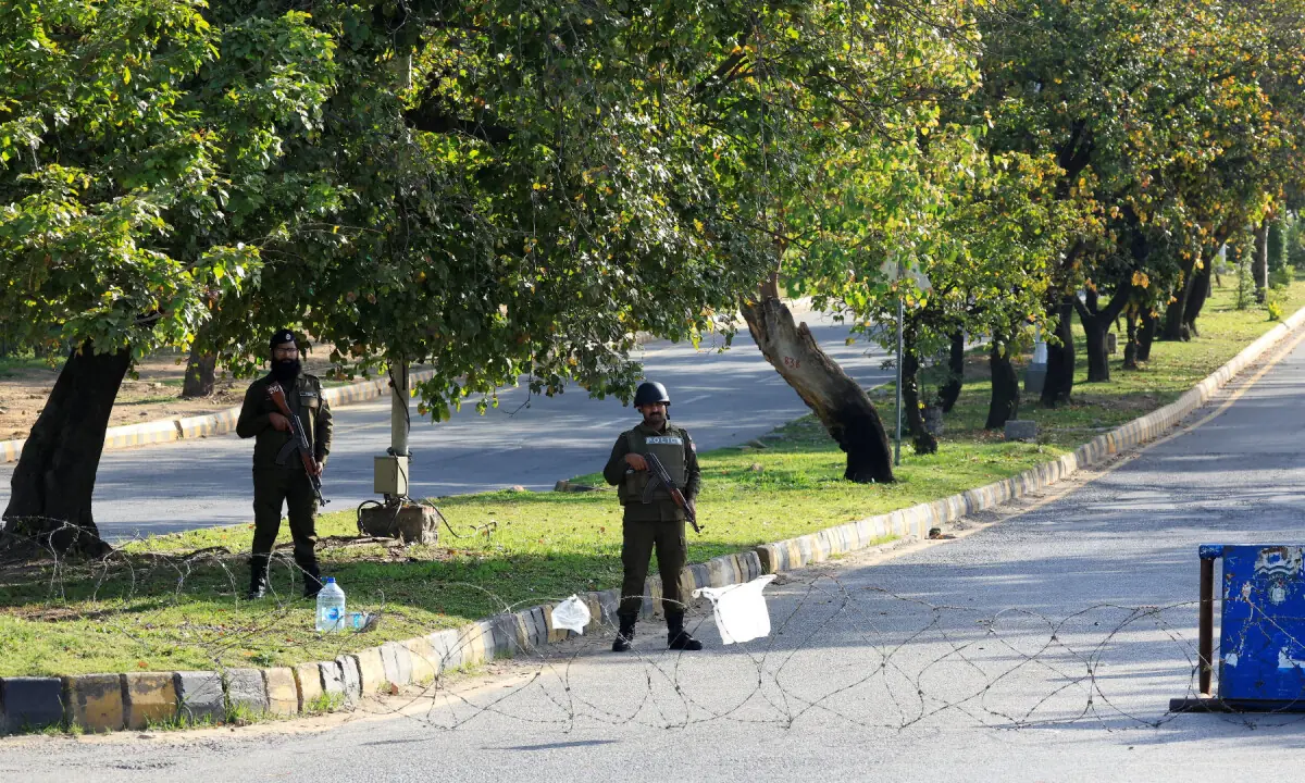 Police officers stand guard at a checkpoint on a road leading to Serena hotel, in Islamabad on April 20, 2026. &mdash; Reuters