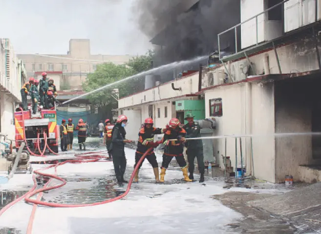  Firefighters try to extinguish the fire erupting in a paint factory on Multan Road. &mdash; White Star  