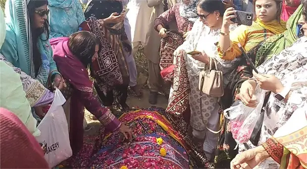  WOMEN activists place flowers on the grave of Khalida Chandio at the Tando Masti graveyard in Khairpur.&mdash;Dawn  