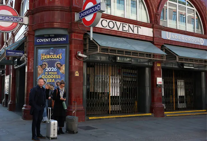 COMMUTERS stand outside London&rsquo;s Covent Garden underground station during the strike.&mdash;Reuters 