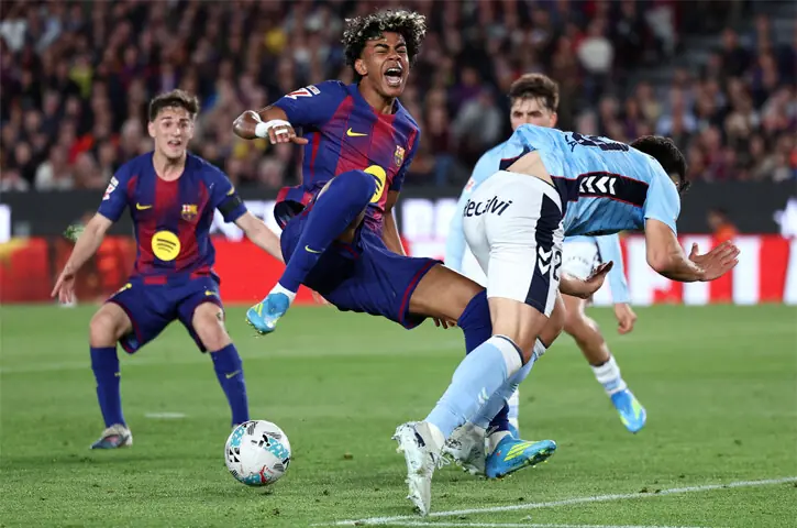   BARCELONA: Lamine Yamal (C) of Barcelona reacts after being fouled by Celta Vigo&rsquo;s Yoel Lago during their La Liga match at Camp Nou.&mdash;AFP  