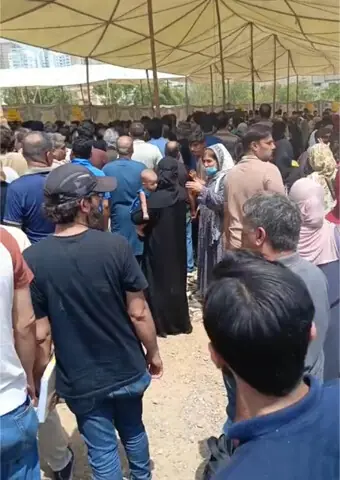    A large number of parents wait for their children outside an exam centre in the scorching sun.&mdash;Dawn   