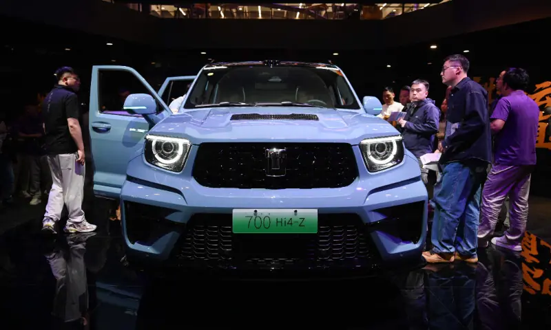 Visitors crowd around a Great Wall Motors sub-brand Tank 700 Hi4-Z at the Beijing Auto Show in Beijing on April 26, 2026. &mdash; AFP