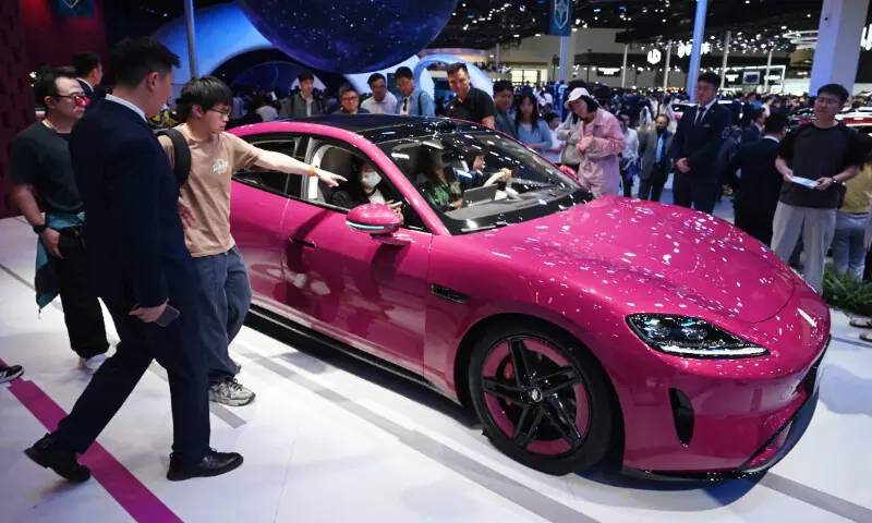 Visitors look at an SAIC Z7 at the Beijing Auto Show in Beijing on April 26, 2026. &mdash; AFP
