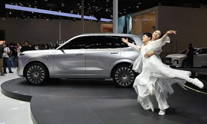 Dancers perform next to a Roewe 07 concept car at the Beijing Auto Show in Beijing on April 26, 2026. &mdash; AFP