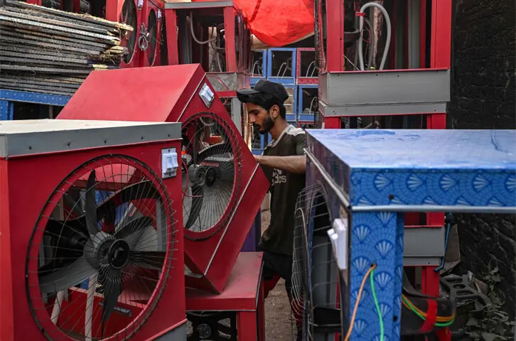   Lahore: A worker assembles an air cooler at a workshop.&mdash;AFP  