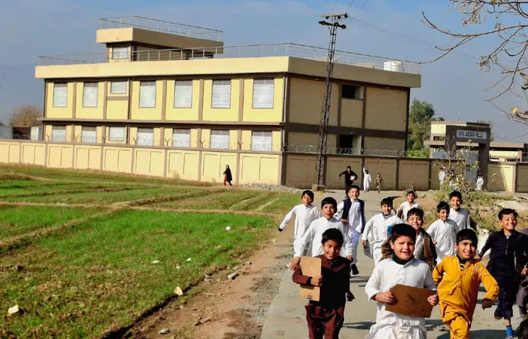 Students rush out of school in Sipah locality of Bara at the dismissal time. &mdash; Photo by Ibrahim Shinwari 