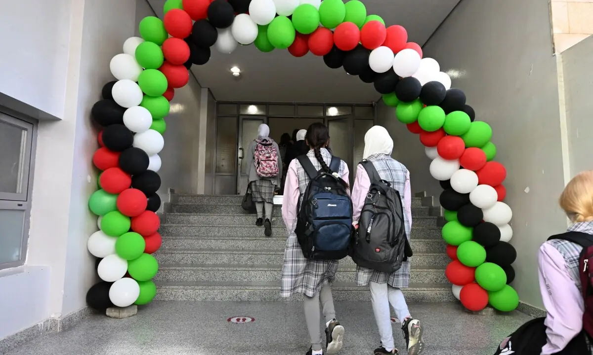 Balloons in the colour of the Kuwaiti flag decorate the entrance to the Fajr al-Sabah Secondary School, as students arrive to attend in-person classes, in Kuwait City on May 3, 2026. &mdash;AFP
