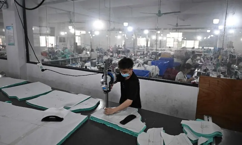 This picture taken on April 27, 2026 shows employees working in a clothing sewing workshop in an urban village in Guangzhou, in southern China&rsquo;s Guangdong province. &mdash; AFP