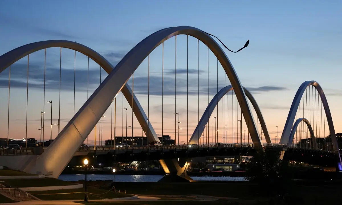 Anti-war protester Guido Reichstadter atop the Frederick Douglass Memorial Bridge in Washington, DC, US on May 5, 2026. &mdash; Reuters