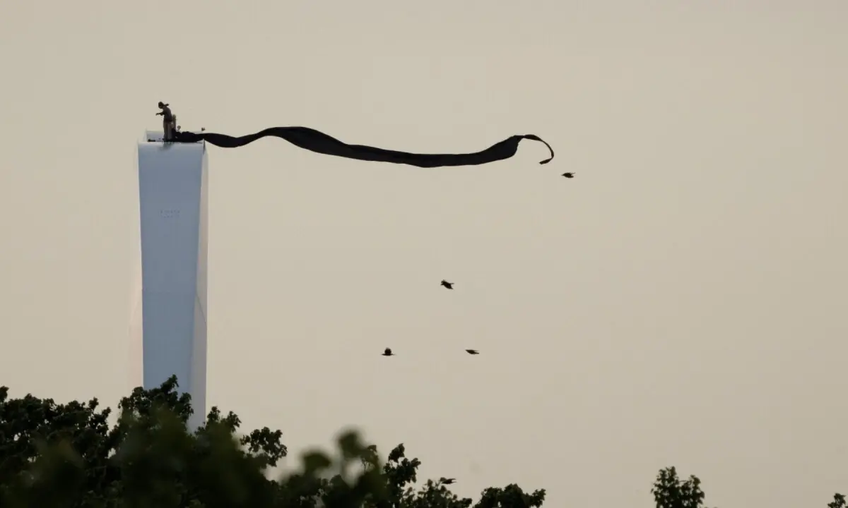 Anti-war protester Guido Reichstadter stands atop the Frederick Douglass Memorial Bridge in Washington, DC, US on May 5, 2026. &mdash;Reuters
