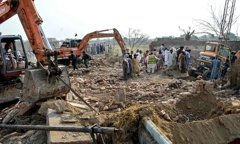 Excavators clear rubble from the destroyed police checkpost following a car bombing attack by terrorists. — AFP