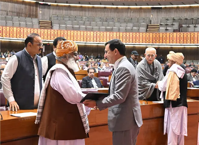 MAULANA Fazlur Rehman greets PTI leader Barrister Gohar Ali Khan during the NA sitting.—Facebook / NAofPakistan