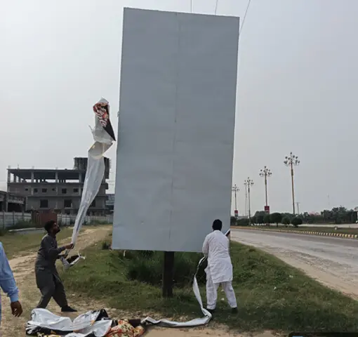  GUJRAT: District council staff removes publicity boards of illegal housing societies along the Main GT Road near Sara-i-Alamgir town. &mdash; Dawn 
