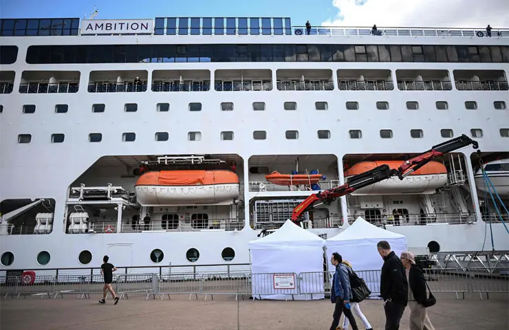 PASSERS-BY walk past the cruise ship at Bordeaux port after passengers were confined following the outbreak of a gastrointestinal illness.—AFP