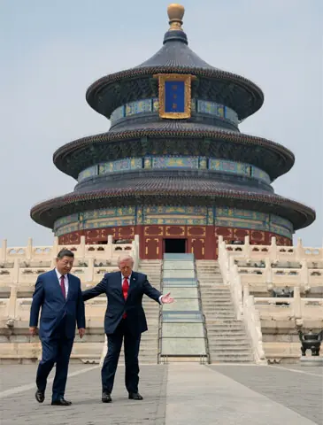 US President Donald Trump gestures to his Chinese counterpart, Xi Jinping, as they arrive at Beijing’s Temple of Heaven for a photo op.—Reuters