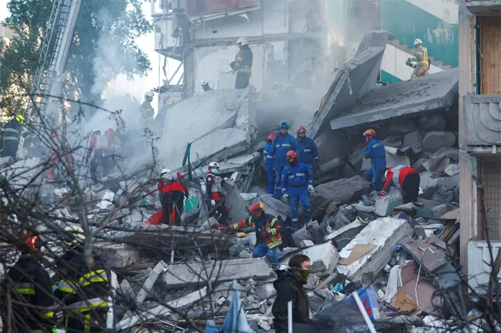 RESCUERS work at the site of a building damaged during Russian missile and drone strikes.—Reuters