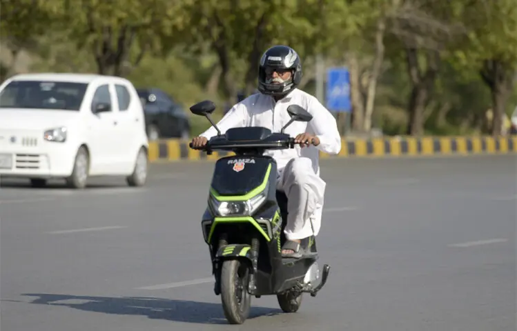  A man driving an e-bike on Islamabad Expressway. &mdash; Photos by Mohammad Asim 