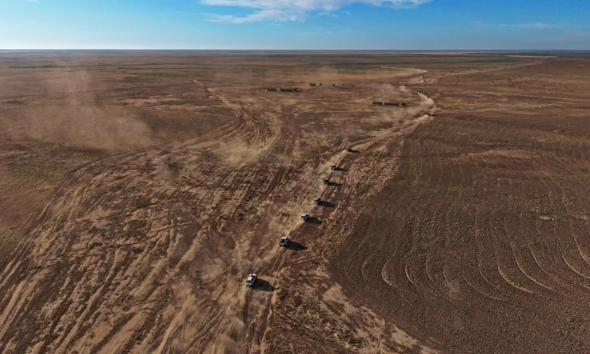 This aerial photograph shows vehicles belonging to the Iraqi Army and the Popular Mobilisation Forces (PMF) driving during a military operation along the desert areas of Al-Hadar and Al-Baaj on May 17, 2026, extending to the border provinces with Syria. &mdash; AFP