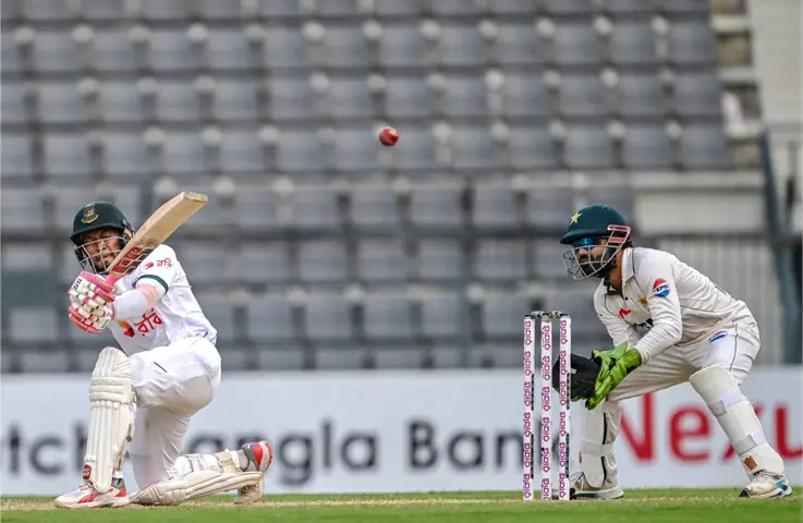   BANGLADESH batter Mushfiqur Rahim plays a shot as Pakistan wicket-keeper Mohammad Rizwan looks on during the second Test at the Sylhet International Cricket Stadium on Monday.&mdash;AFP 