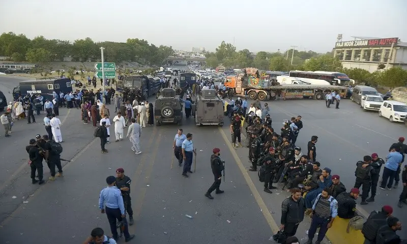 Police personnel form a line to stop PTI workers and leaders from proceeding towards the prison. — Mohammad Asim