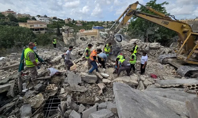 Lebanese civil defence workers search through the rubble in the southern Lebanese village of Deir Qanun al-Nahr on May 20, 2026. &mdash;AFP