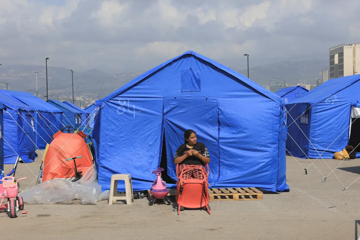 A woman sits in front of a tent at the Beirut waterfront, in Beirut, Lebanon, May 21, 2026. &mdash;Reuters