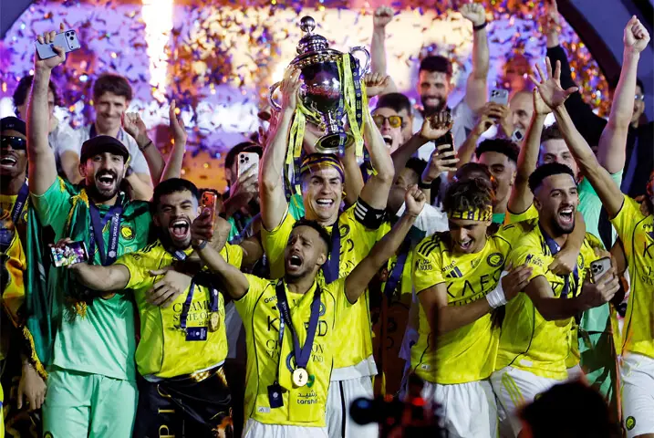 RIYADH: Al Nassr’s Cristiano Ronaldo lifts the Saudi Pro League trophy as he celebrates with team-mates following their title-sealing win against Damac at the Al Awwal Park.—Reuters
