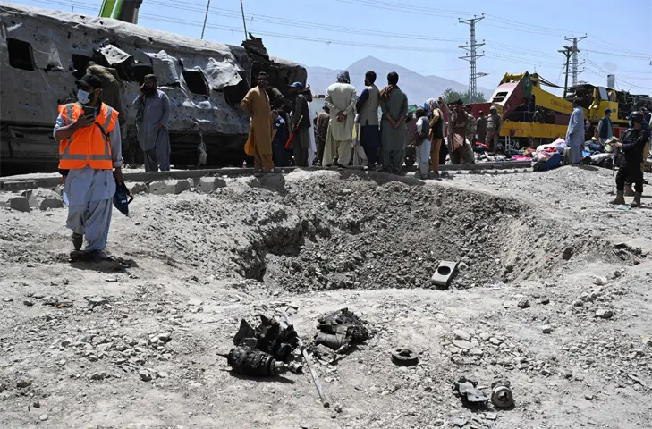  PEOPLE gather around the crater left by the blast.&mdash;AFP 
