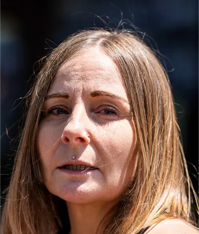 Kim Prosser, whose son died by suicide after using a chemical sold by Kenneth Law, speaks to media outside the court in Newmarket, Canada.—Reuters