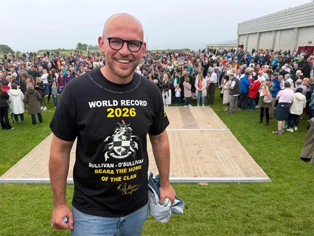 Castletownbere (Ireland): Ross Maher O’Sullivan poses in front of participants in a bid to break a world record for the largest gathering of people with the same surname.—AFP
