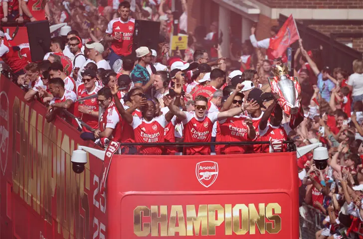  LONDON: Arsenal players celebrate with the Premier League trophy during the victory parade, around the streets near the Emirates Stadium, on Sunday.&mdash;Reuters 