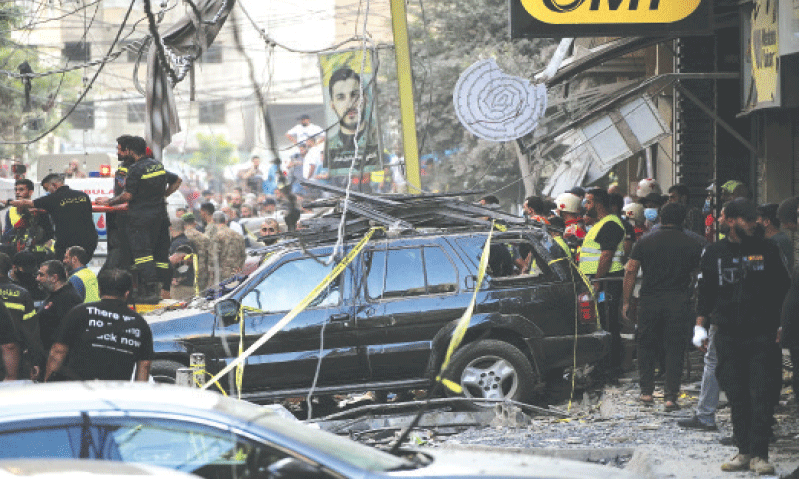 Lebanese civil defence members gather near a building, destroyed by an Israeli air strike.—Reuters/File