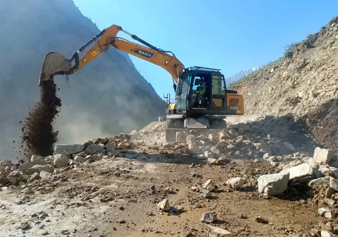  A machine removes the debris after a landslide blocked Kalam-Mahodand Road in Swat on Monday. &mdash; Dawn 